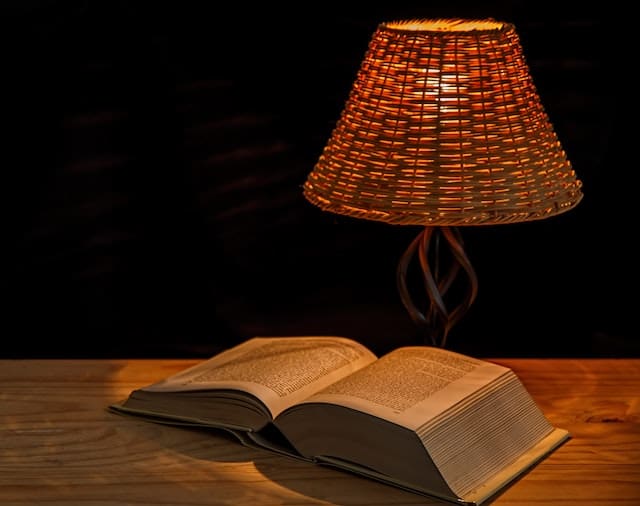 night lamp with the book opened image in the dark room
